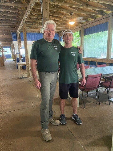 Jake Hilley is seen with Troop 277 onsite leader, Jamie Kranking, who oversaw the cutting and assembly of the tables.